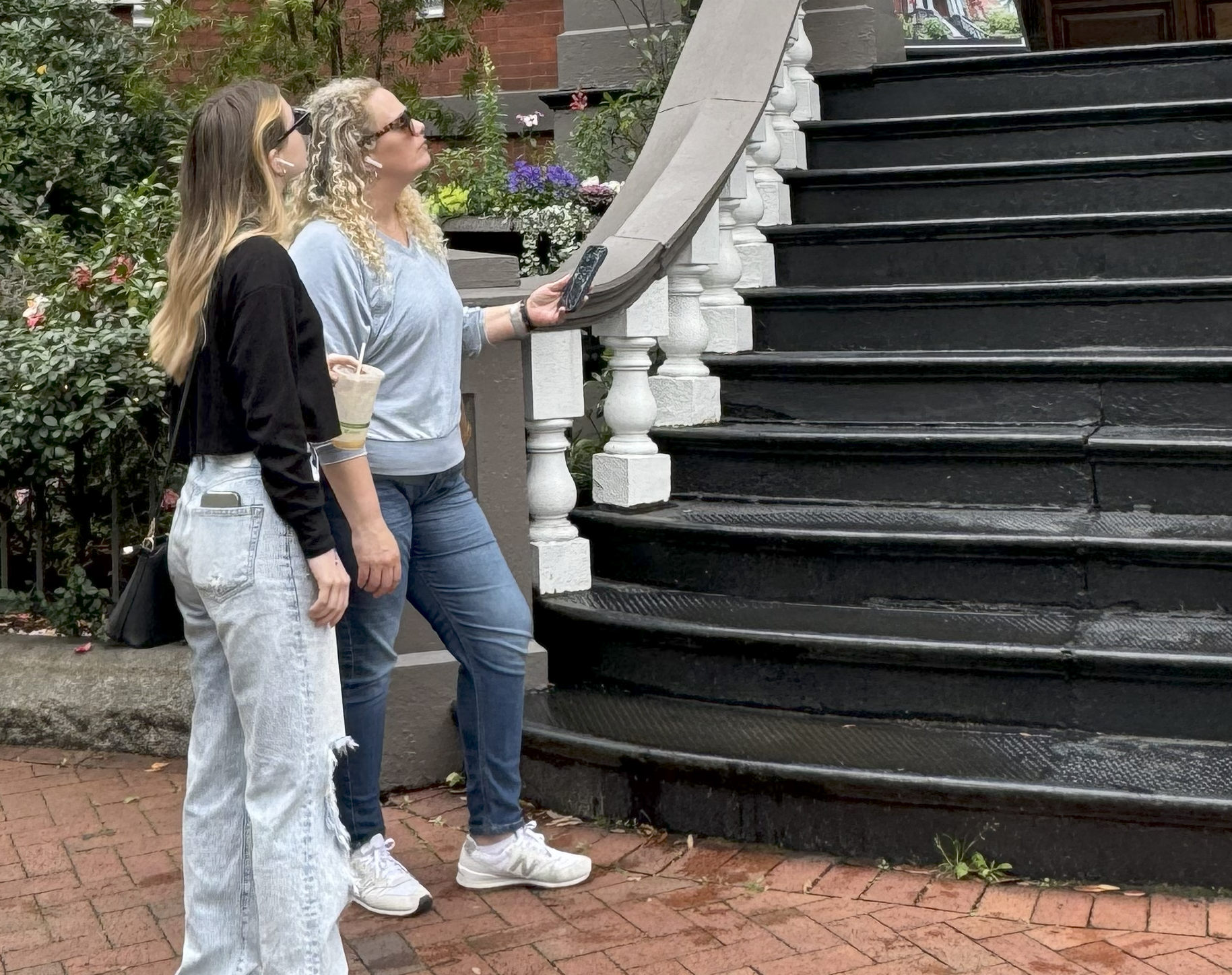 Person exploring historic downtown area with smartphone audio tour